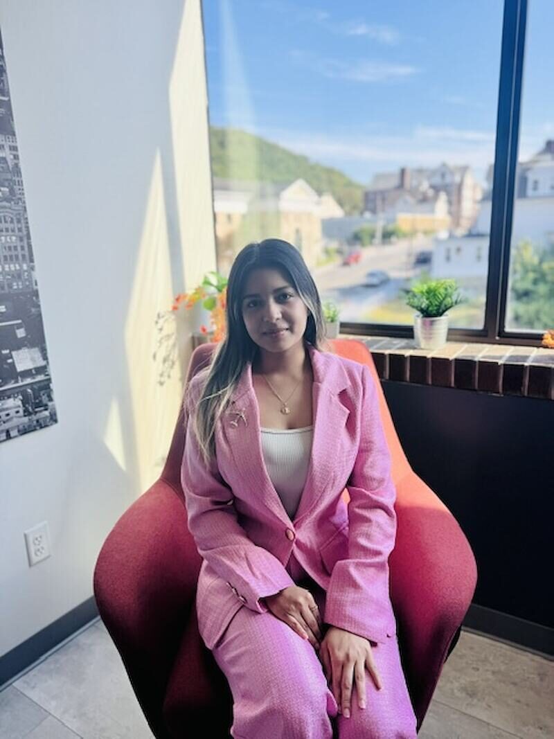 Gretchen Munguia, Chief Executive Officer of Relentless Marketing, seated in the Middletown office