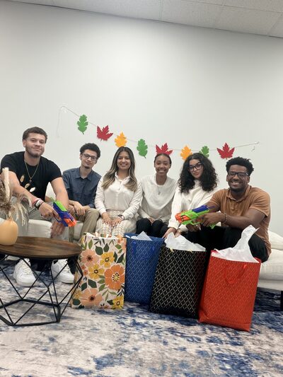 Team members sitting together with gift bags at an office holiday exchange