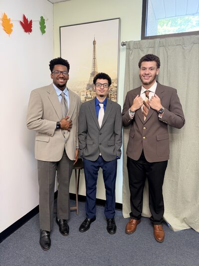 Three team members in suits before heading out to a client campaign