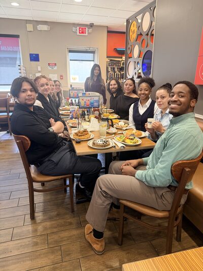 The team gathered around a long table for breakfast out together